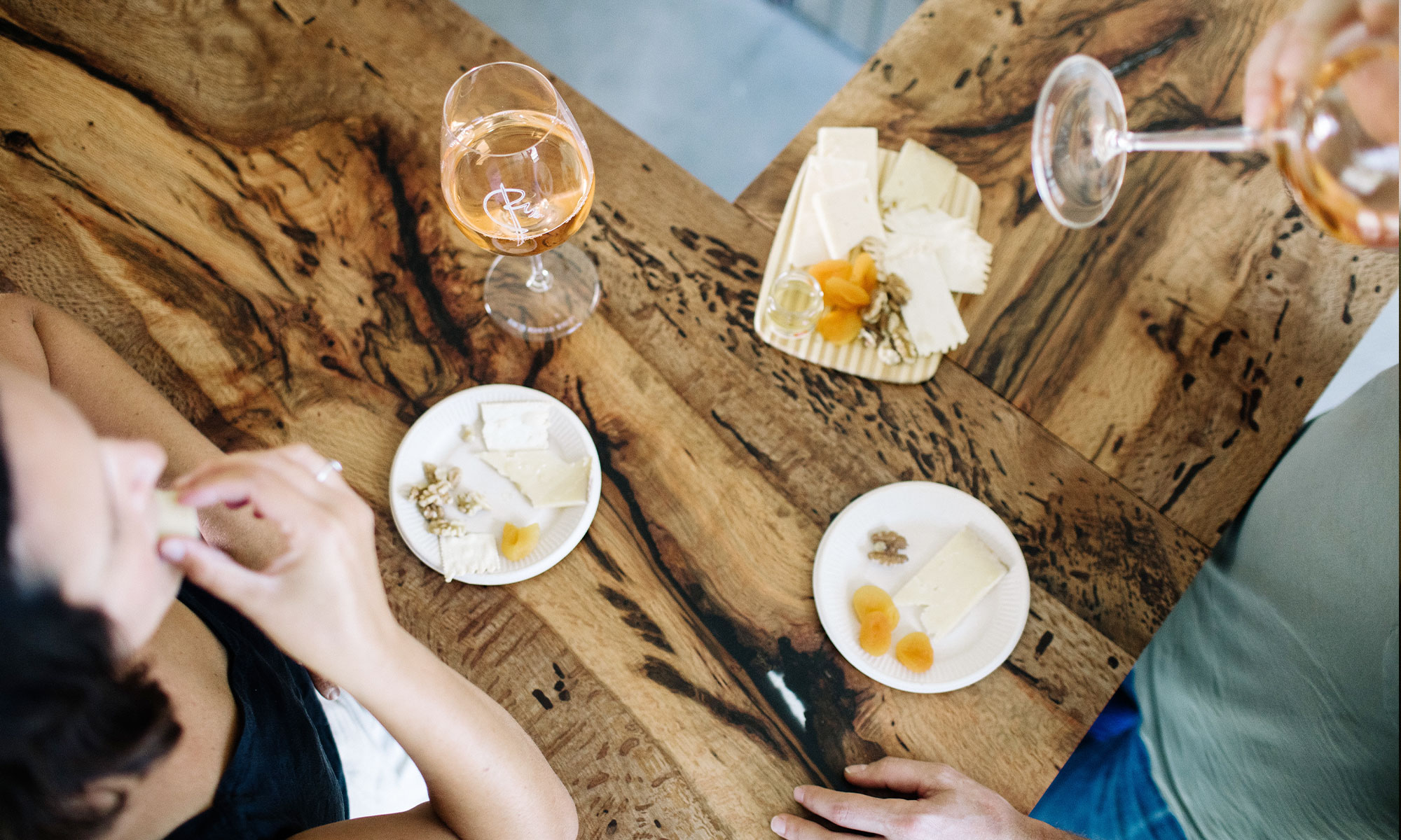 A couple enjoys a cheese plate and wine at the tasting room in Carpinteria